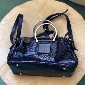 Lovely gently used Patricia Nash handbag satchel . The color is black/violet
